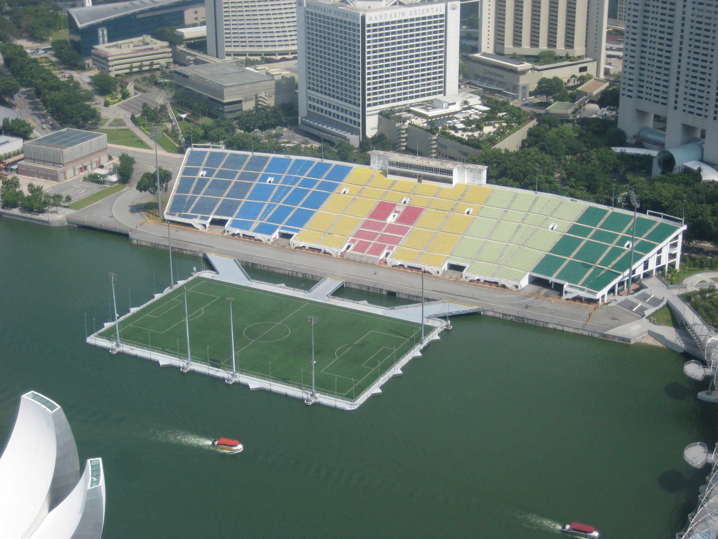 Fans with flags in the floodlit grandstands of Marina Bay Street Circuit